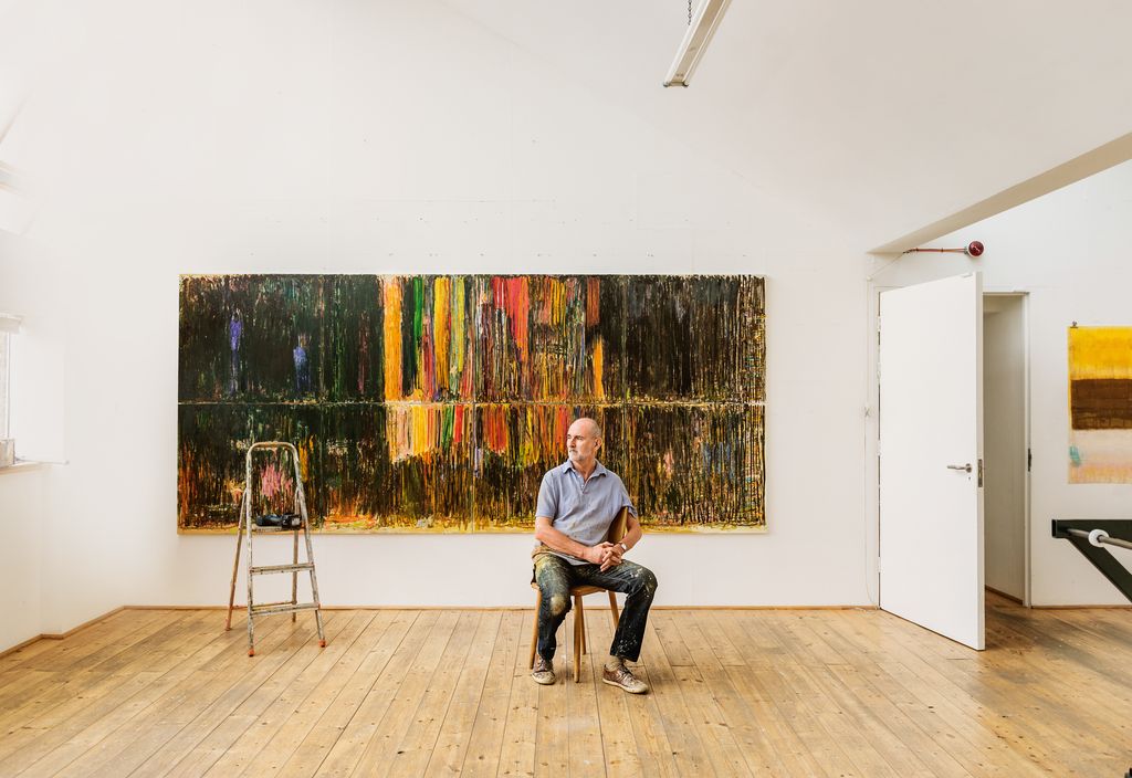 Christopher in his lightfilled studio in front of his large oil painting Solent 2021