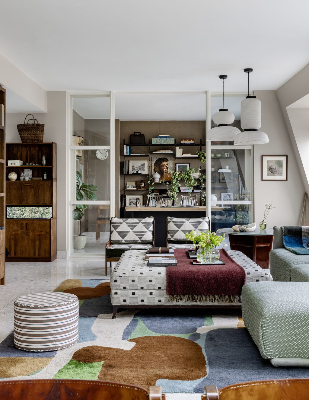 On the other side of the sitting room is the study. The glass doors throughout allow for the flow of light.