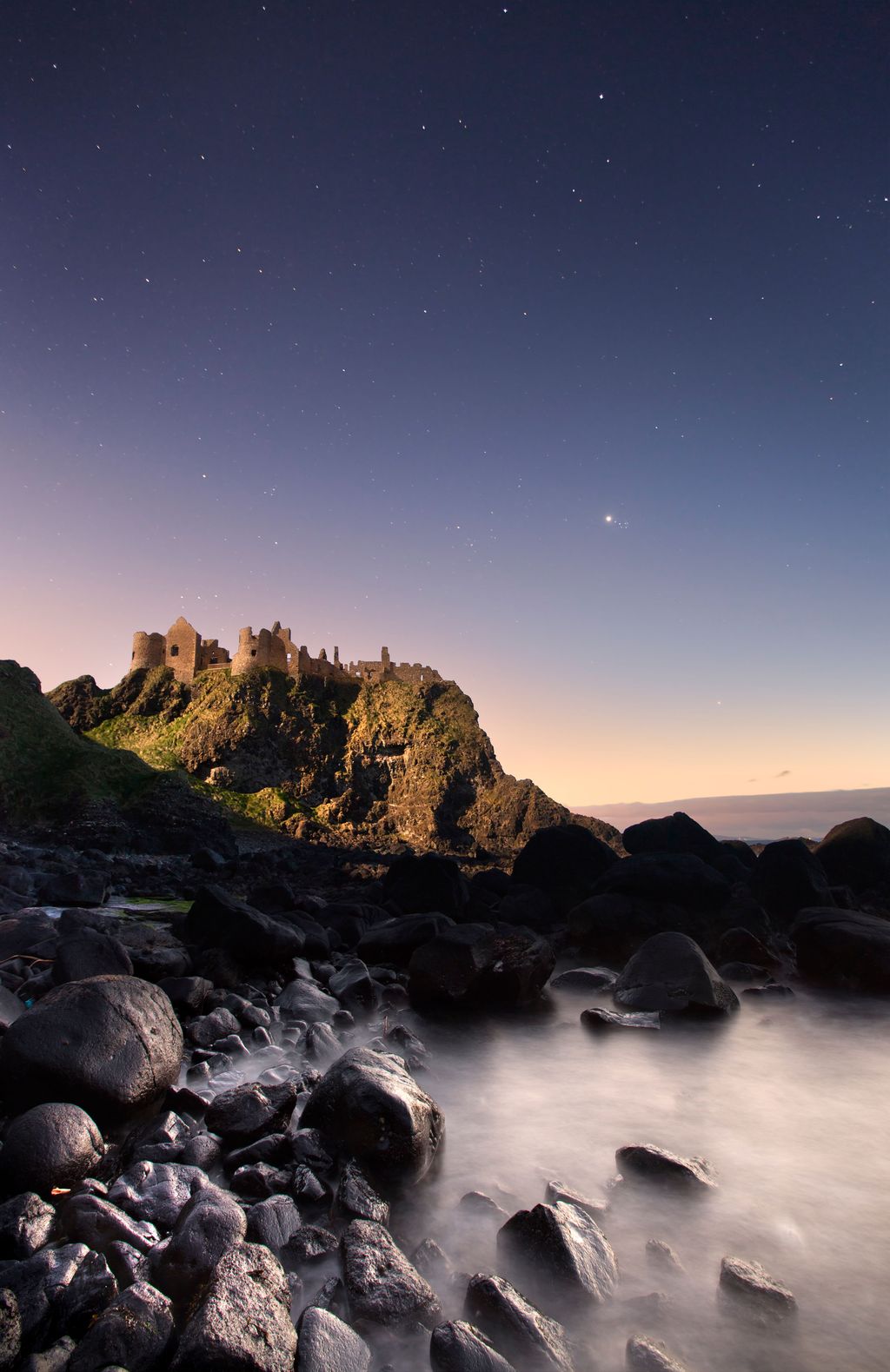Now abandoned the medieval castle of Dunluce stands high above the crashing waves and rocks of the north coast of...