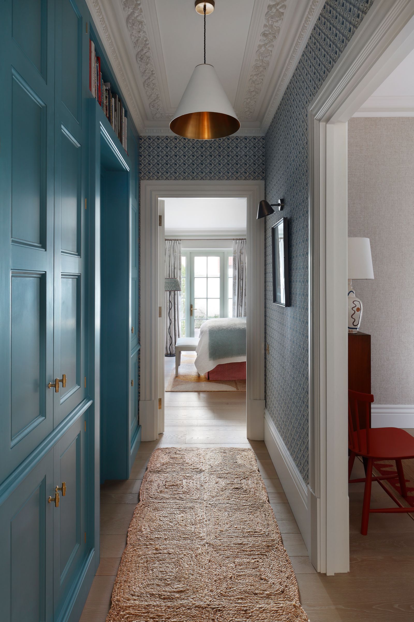 In the corridor the joinery is painted in Blues Blue by Paint and Paper Library. The wallpaper is by Antoinette Poisson...