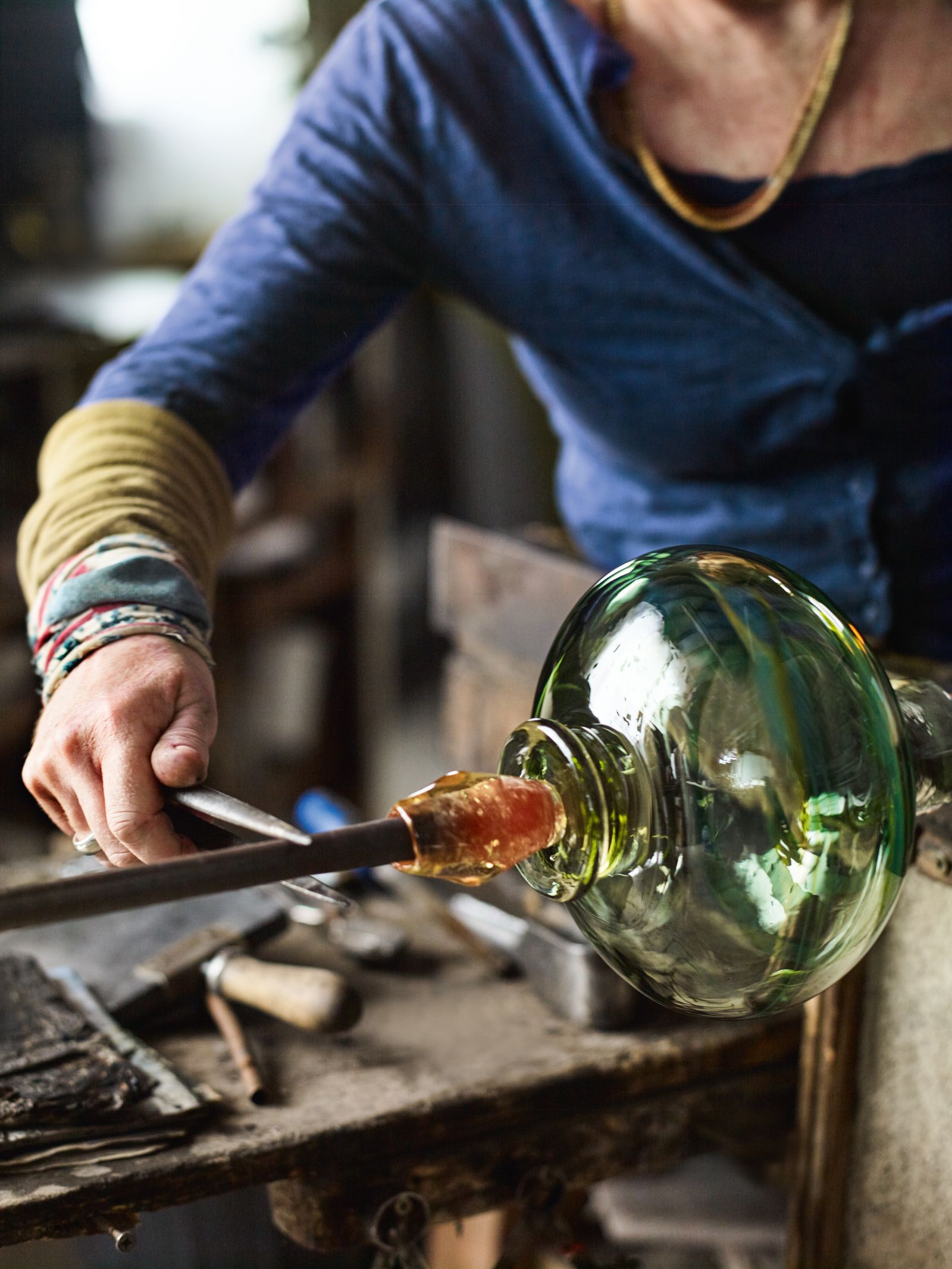 A pontil is used to remove a piece from the blowing iron.