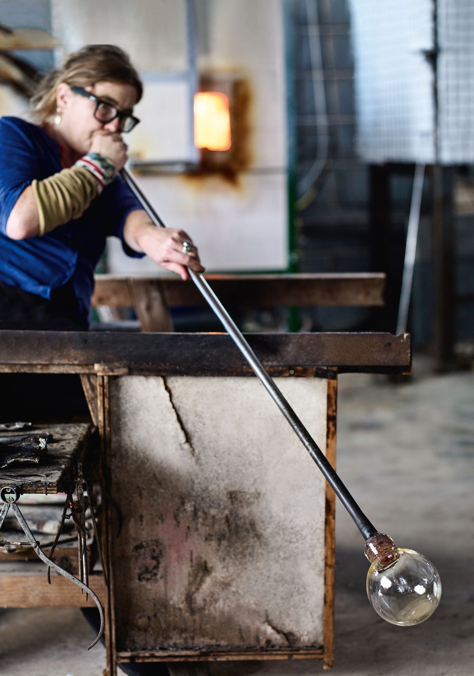 Blowing molten glass