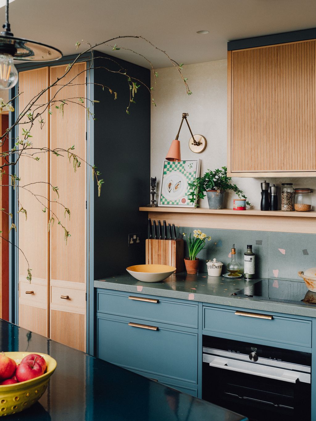 In another part of the kitchen in the same London house the pantry doors feature a reeded design with antique brass...