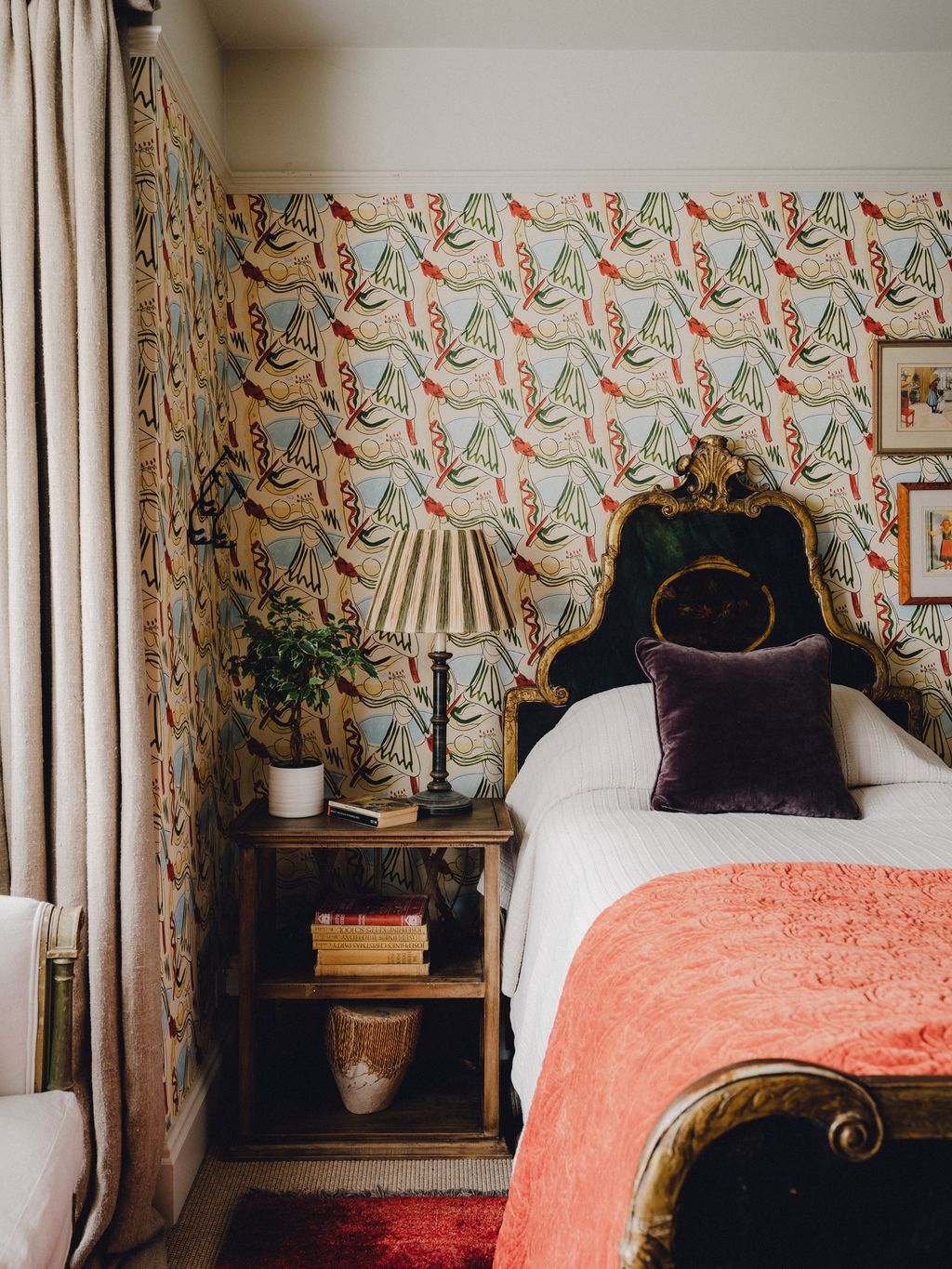 In a further spare room Whiteworks' ‘Rites of Spring wallpaper provides a colourful background while raffia lampshades...
