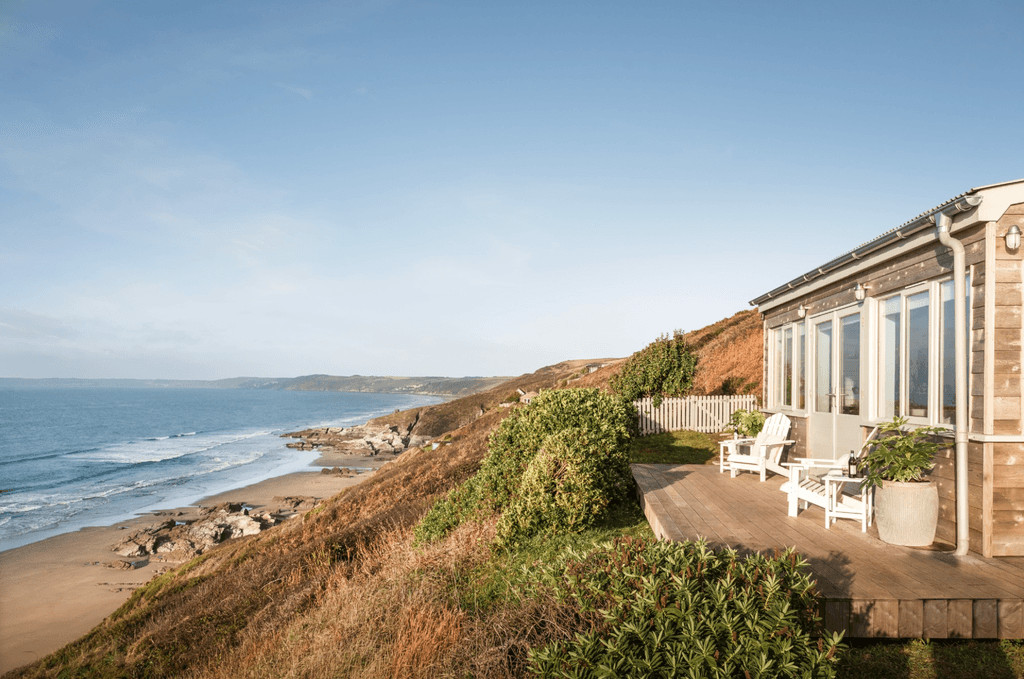 High above the crashing waves and churning sand piles of Whitsand Bay sits the glorious cottage Aurora. With its...