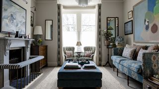 In the sitting room walls in Edward Bulmer's ‘Dove provides a neutral backdrop for art and patterned textiles. The...