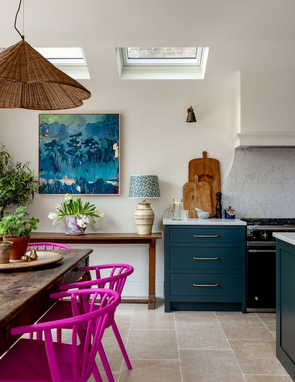 Polly extended the kitchen both outwards and to the side return of the house. The pink chairs add a pop of colour. The...