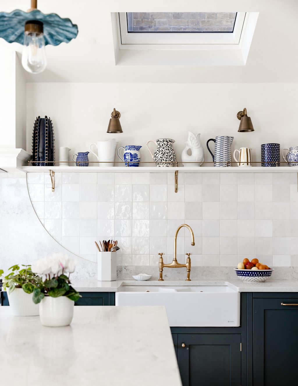 Two ‘Club Wall Lights by Jim Lawrence illuminate Polly's collection of ceramic objects.