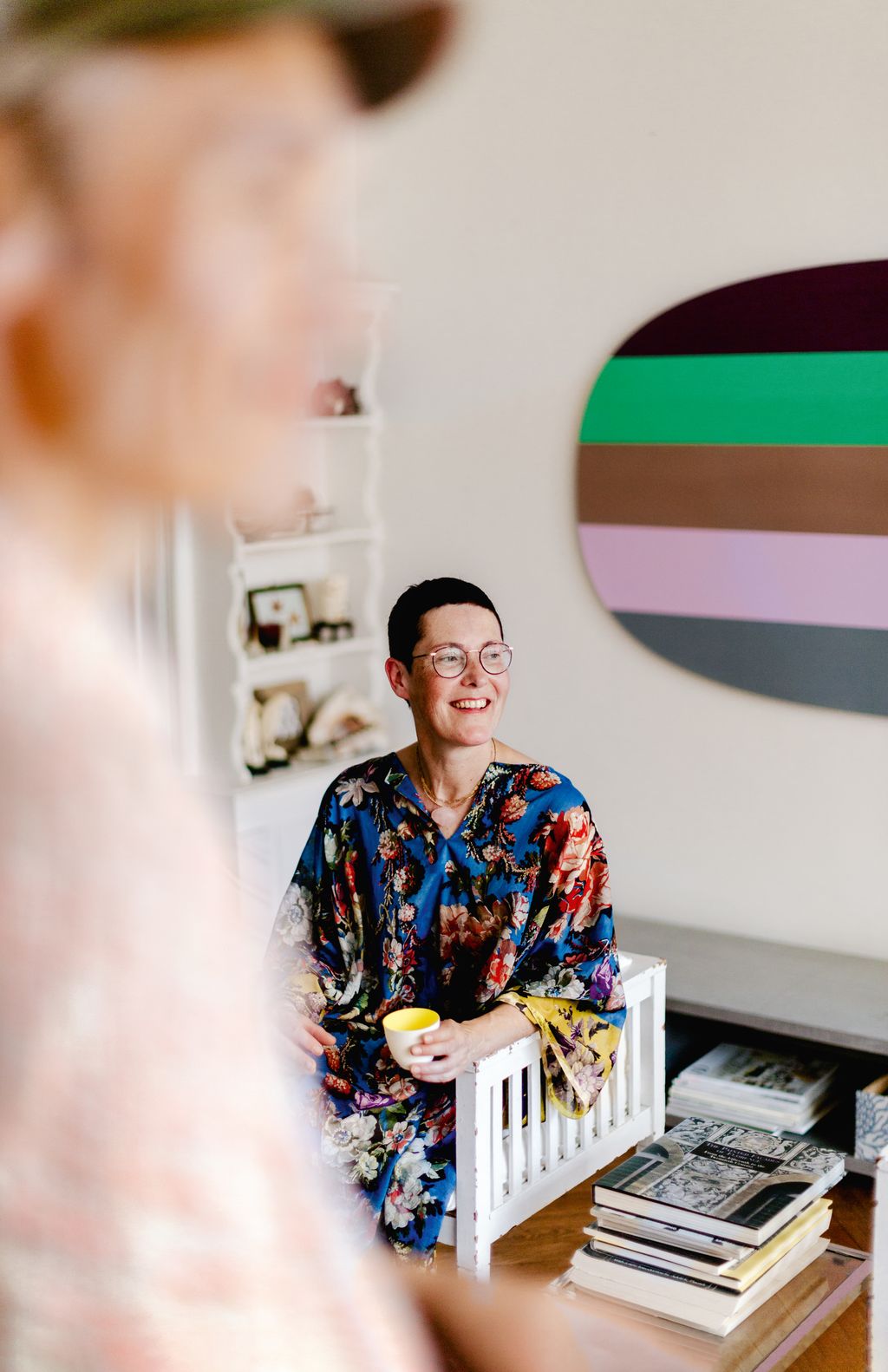 Jacqueline in the sitting room in front of one of their pieces