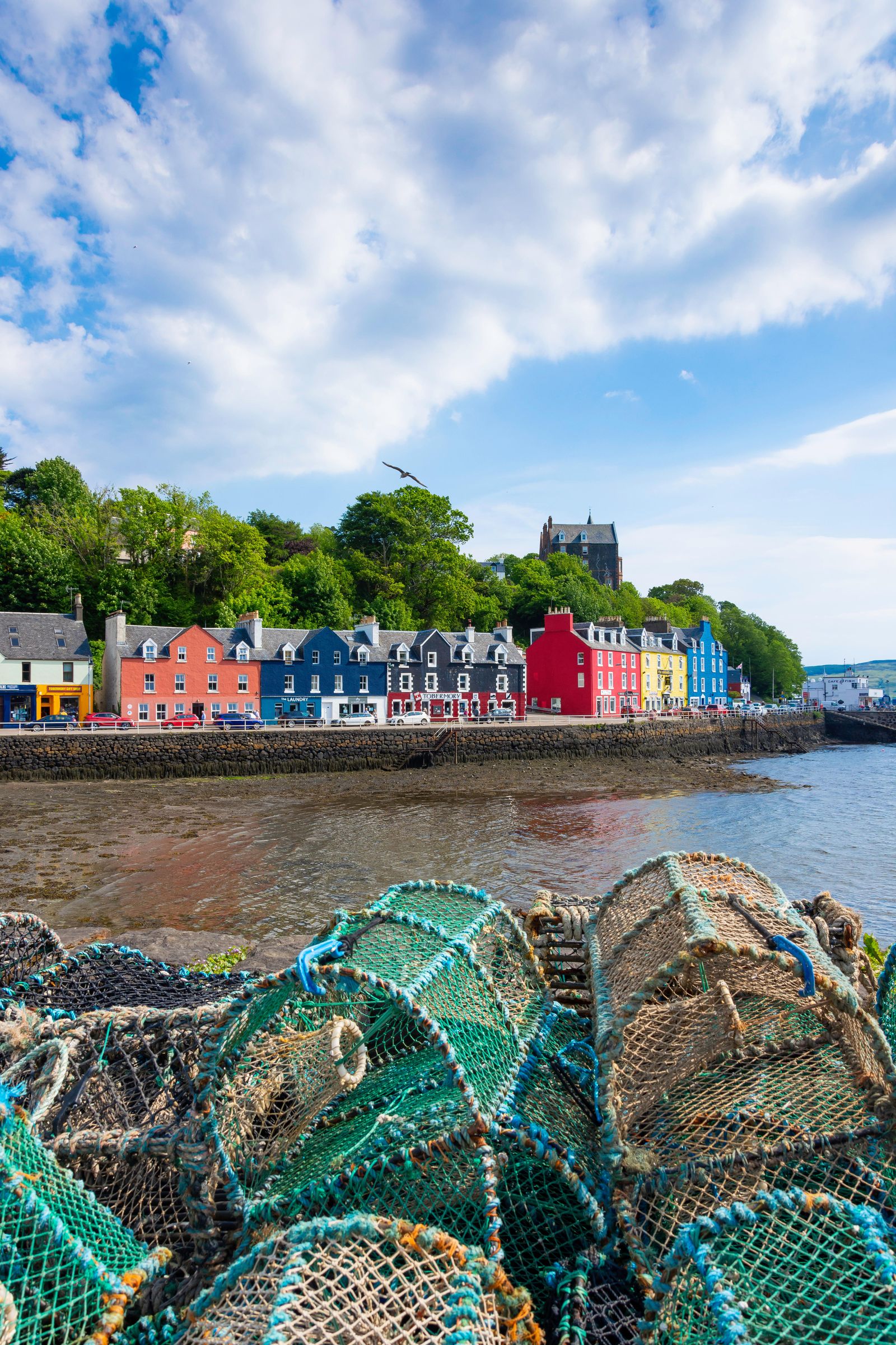 P0FYMB Colourful houses and lobster pots on quayside Tobermory Isle of Mull Inner Hebrides Argyll and Bute Scotland...
