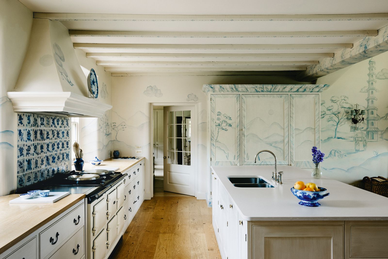 In the kitchen the cabinetry by Carlton Smith with French oak and Silestones ‘Yukon worktops was handpainted by Will...