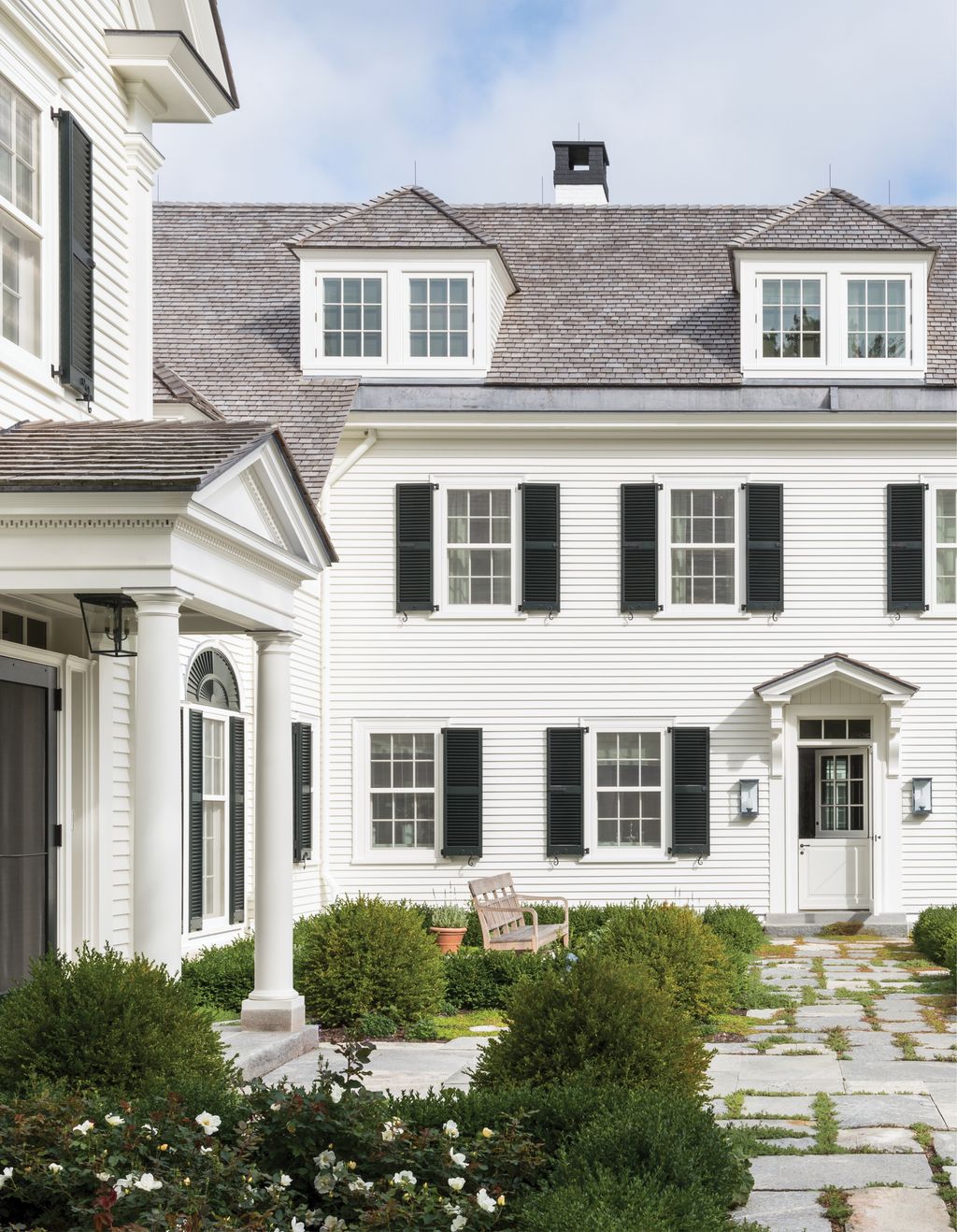 The simple classically inspired entrance to the main house keeps the spirit of the original residence that stood here...