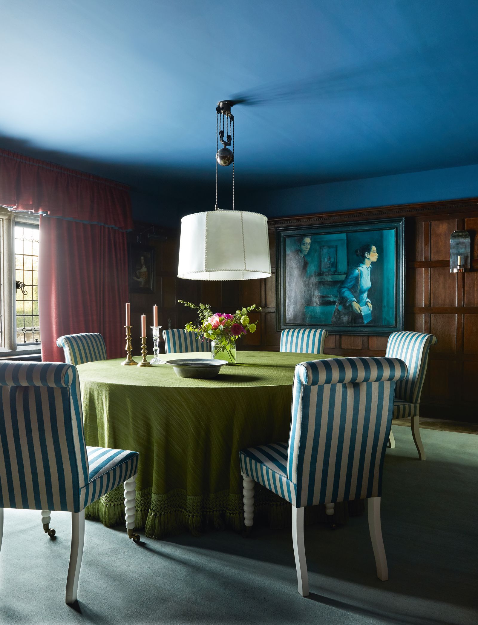 A ‘Double Rise and Fall light from Soane hangs over a table paired with Howes ‘Bobbin Leg chair in the dining room.