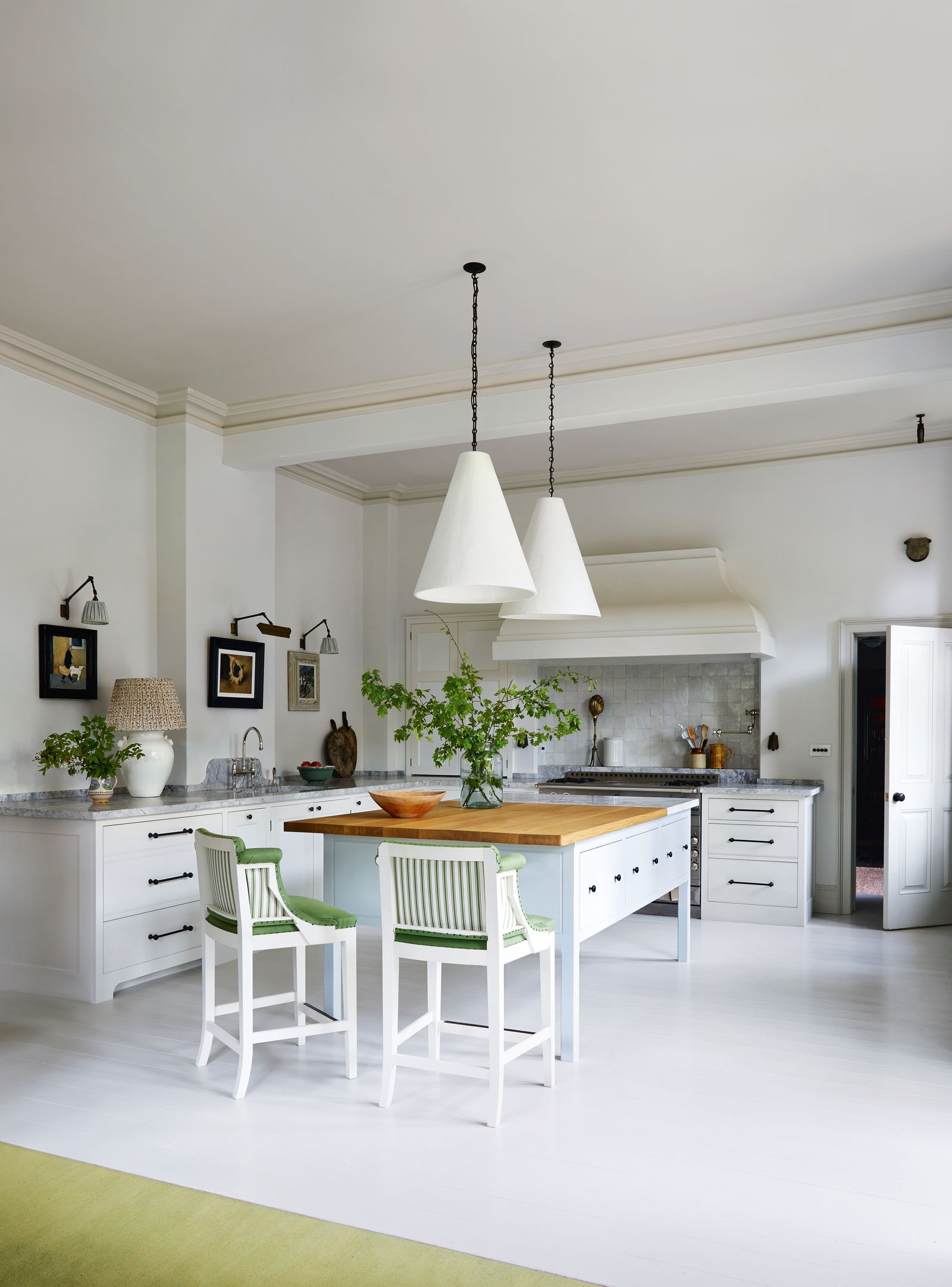 The Plain English island in the kitchen is partnered by Howe Londons ‘Whippet stools with Rose Uniackes ‘Plaster Cone...