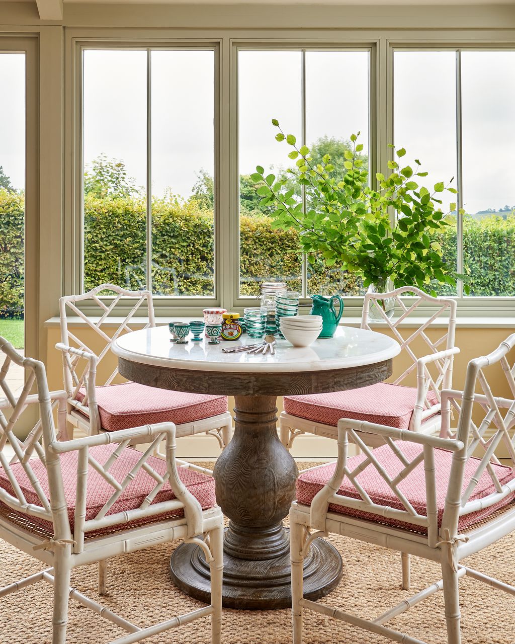 The white bamboo chairs in the kitchen dining area are antique finds from Ron Green Antiques.