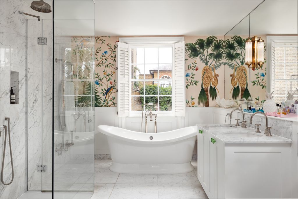 DeGournay's ‘Amazonia wallpaper creates a tropical feel in the master bathroom.