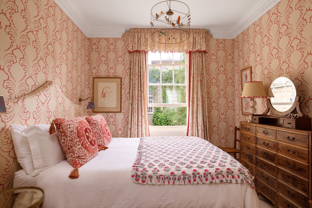 The wallpaper curtain and headboard fabric are all Soanes 'Pineapple Frond'.