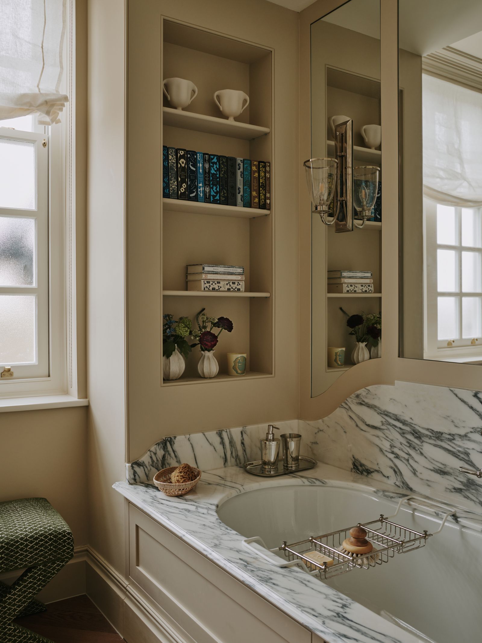 A builtin bath in a Mayfair apartment by Salvesen Graham where the layout allows for a deep marble surround builtin...