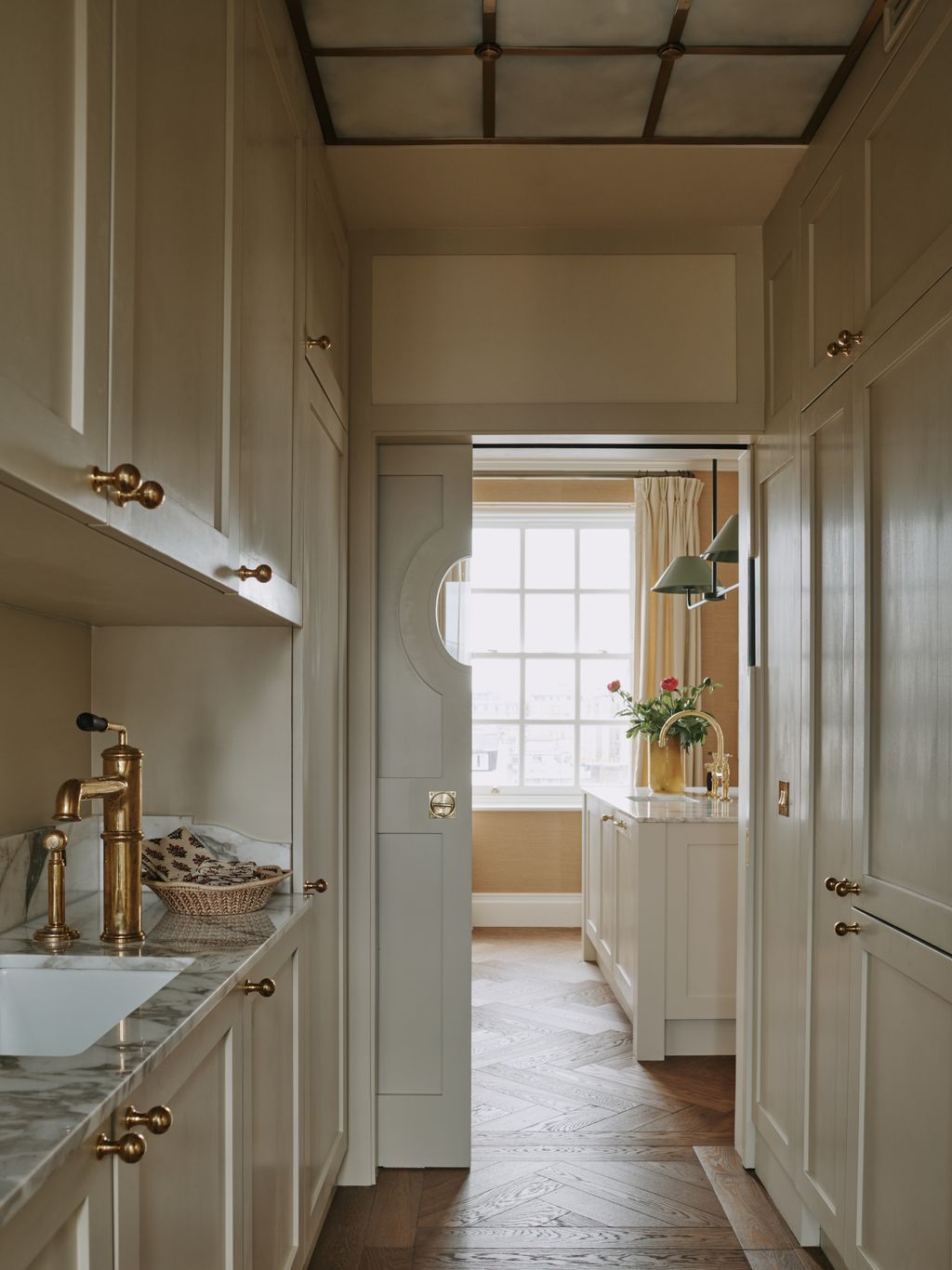 This small utility room was made more interesting with a specially designed ceiling with brass sections and light...