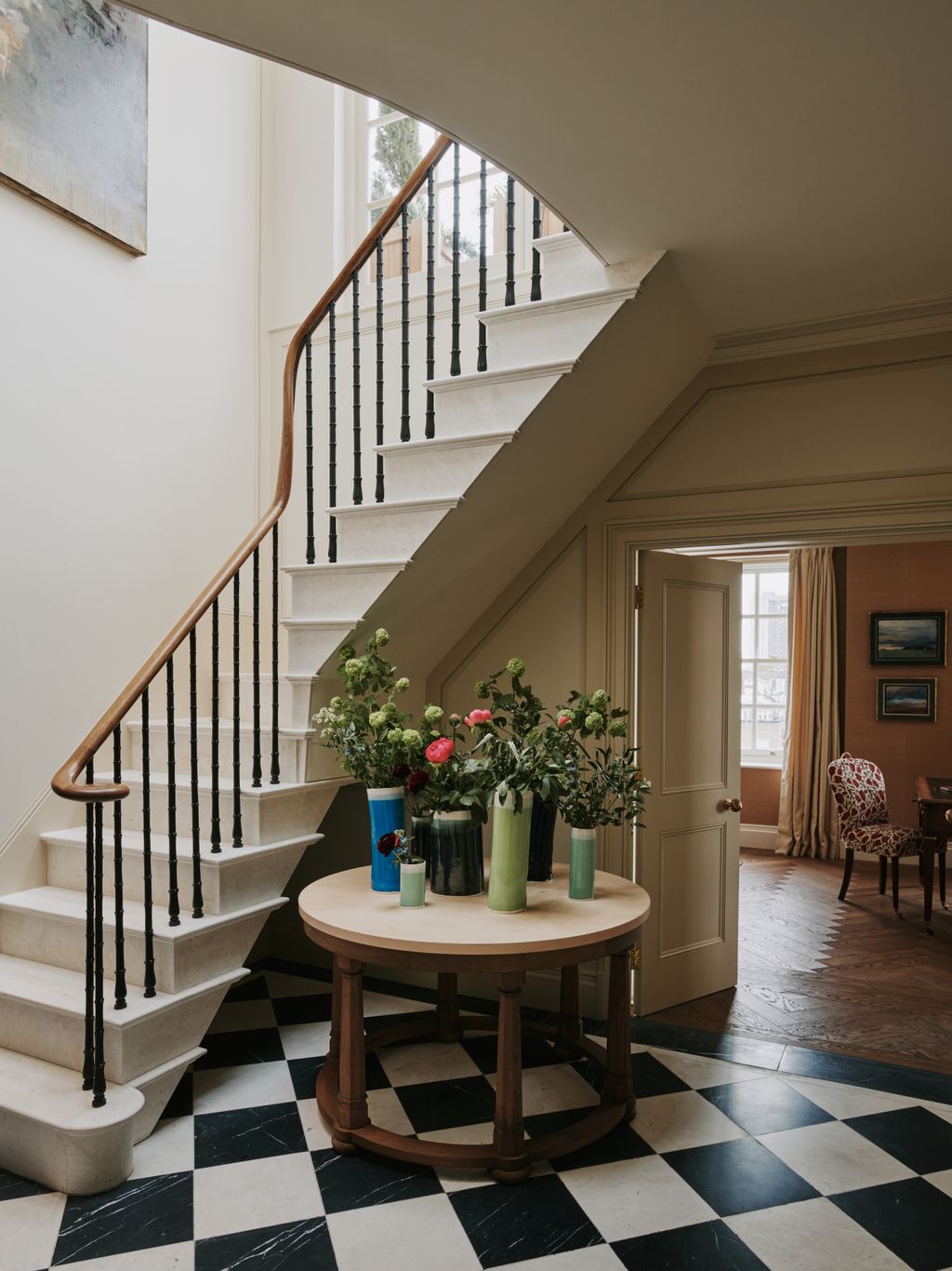 The floor and stone staircase give this Mayfair apartment grandeur beyond its square footage.