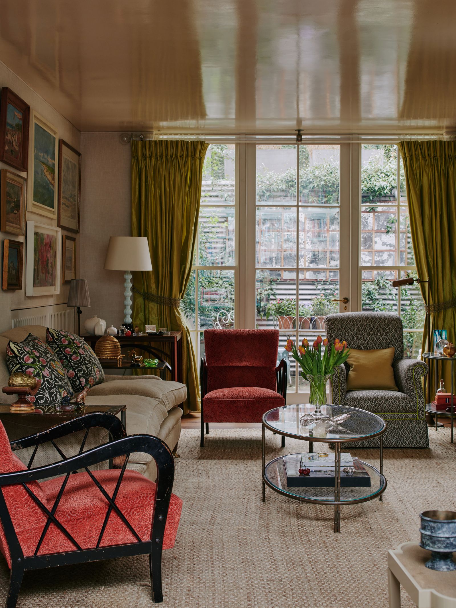 Nina Campbell's rounded bronze bamboo coffee table in her house in London