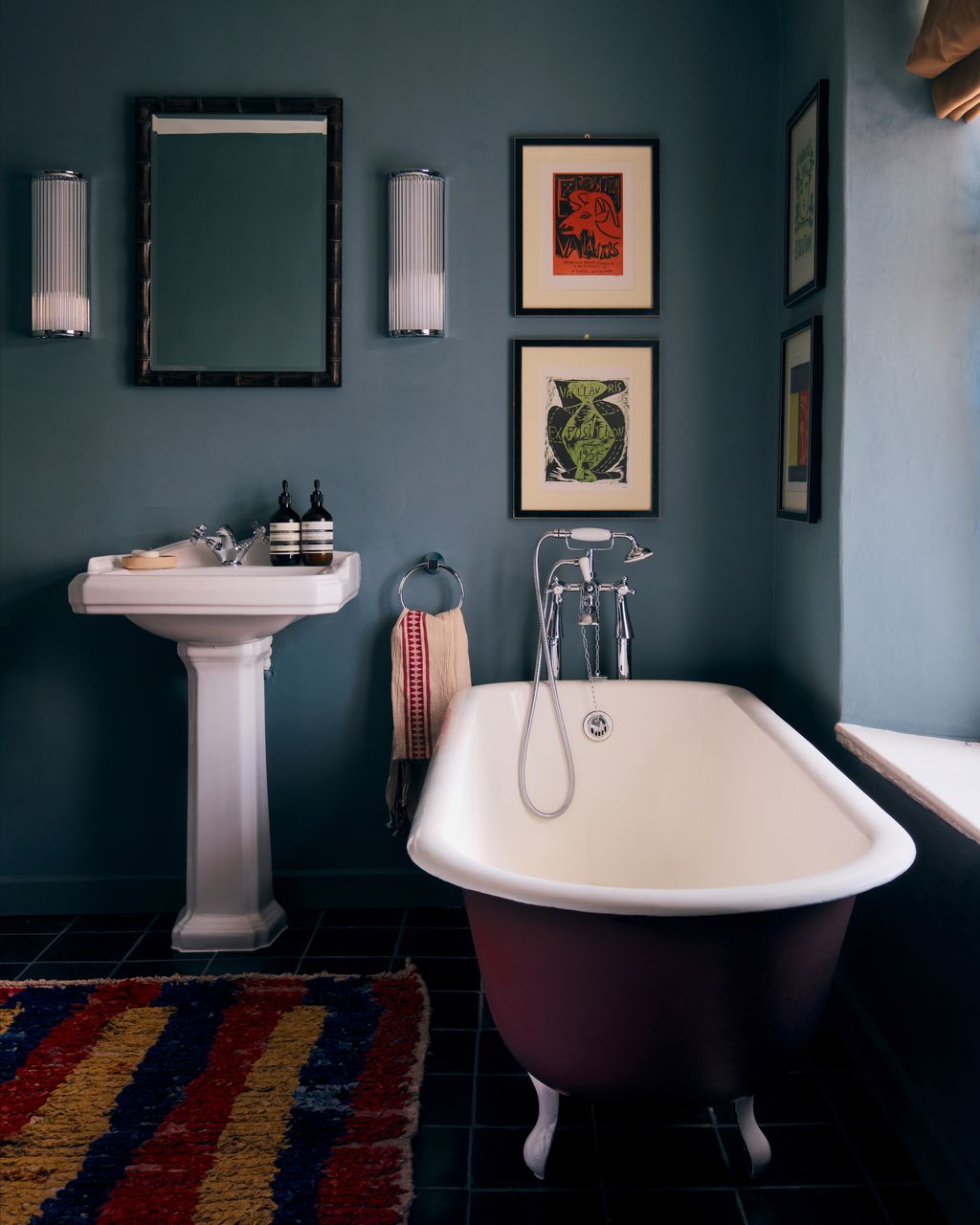 In the master bathroom the walls are painted ‘Ede by Atelier Ellis. The rug is from Larusi. The prints are original...