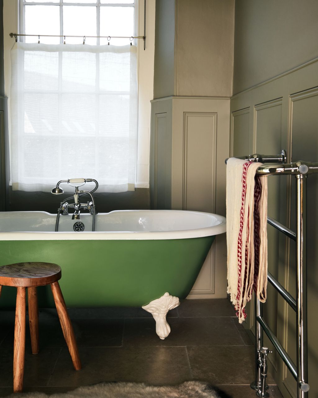 On the walls of the family bathroom are covered in panelling Tom designed to ‘introduce some charm back into the room...