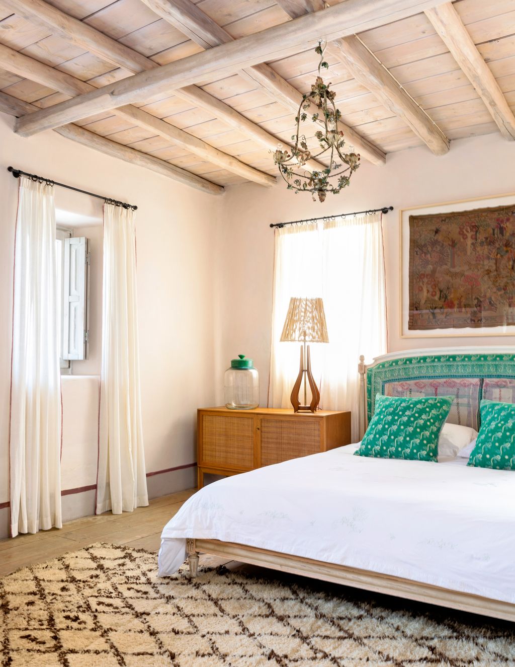 A headboard and cushions made of Indian kantha quilts bring colour to a spare room.
