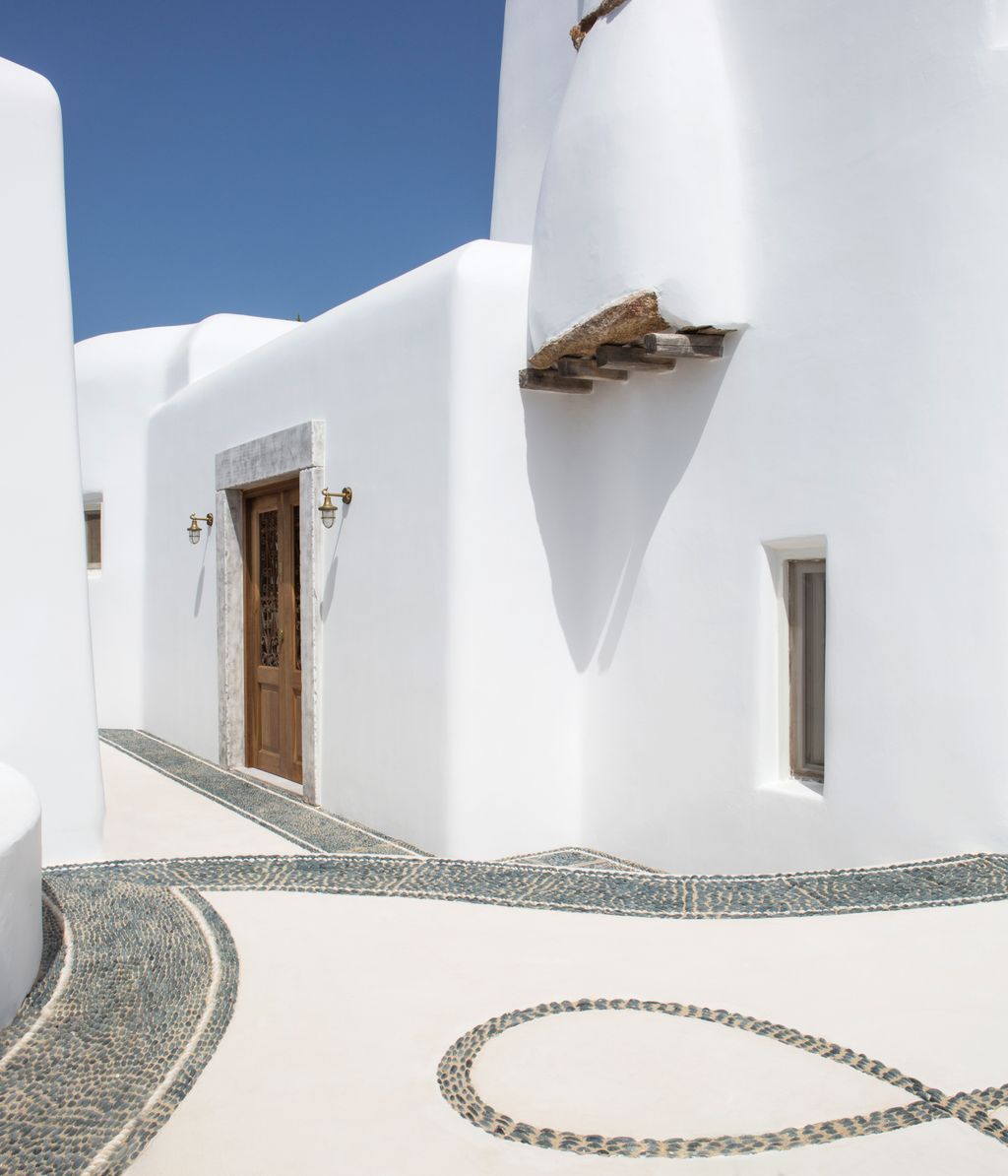 Traditional pebblework using black stones from the island of Chios decorates the path to the front door.