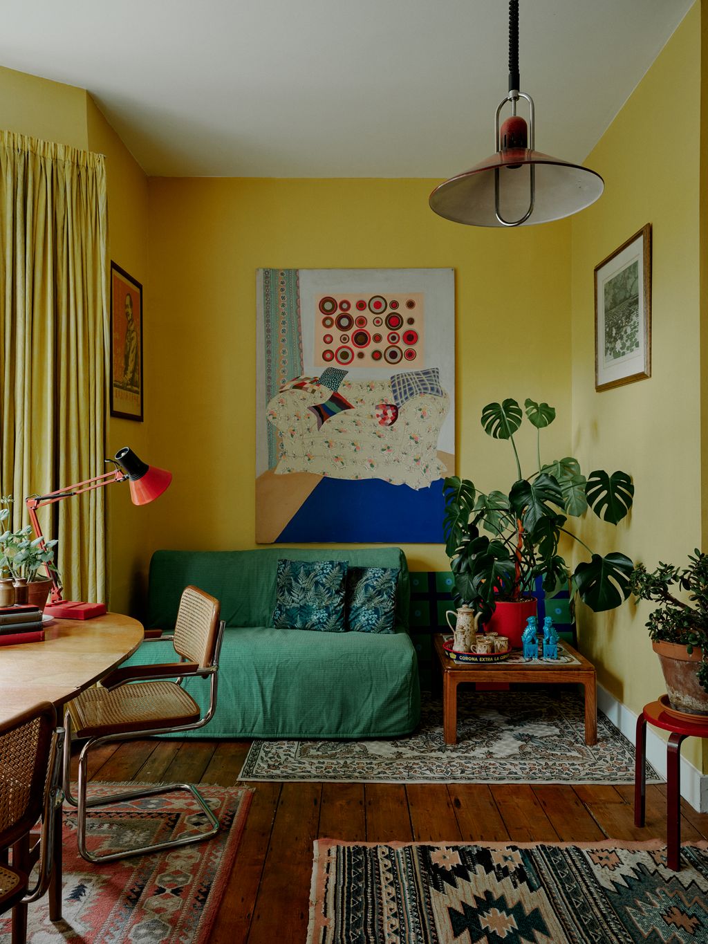 The large painting is a family heirloom by Lady Mary Tambini. It sits above a green Ikea sofa bed.