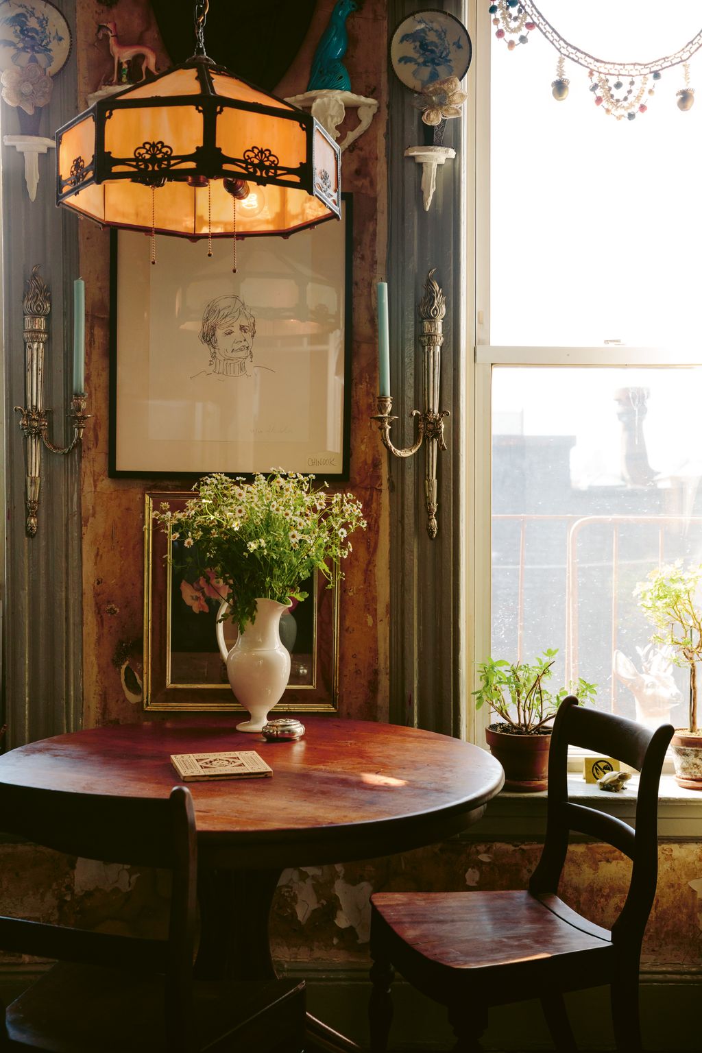 An eclectic mix of antique and vintage pieces furnishes the rooms of their home