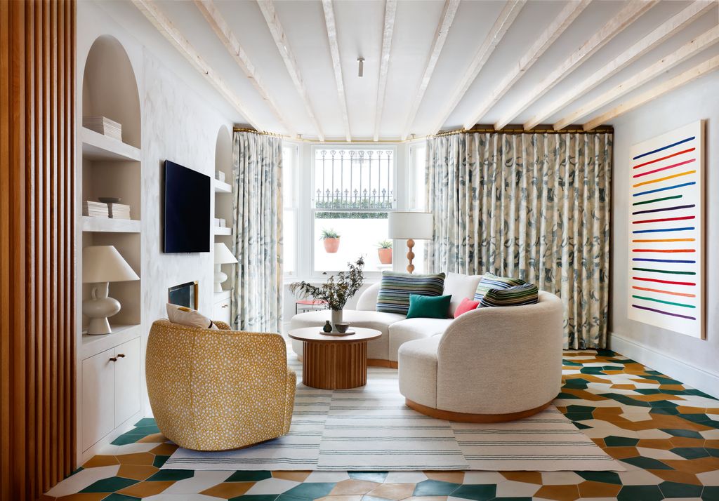 Sarah Peake of Studio Peake has ingeniously extended the curtains across the wall of this house in Chelsea. The...