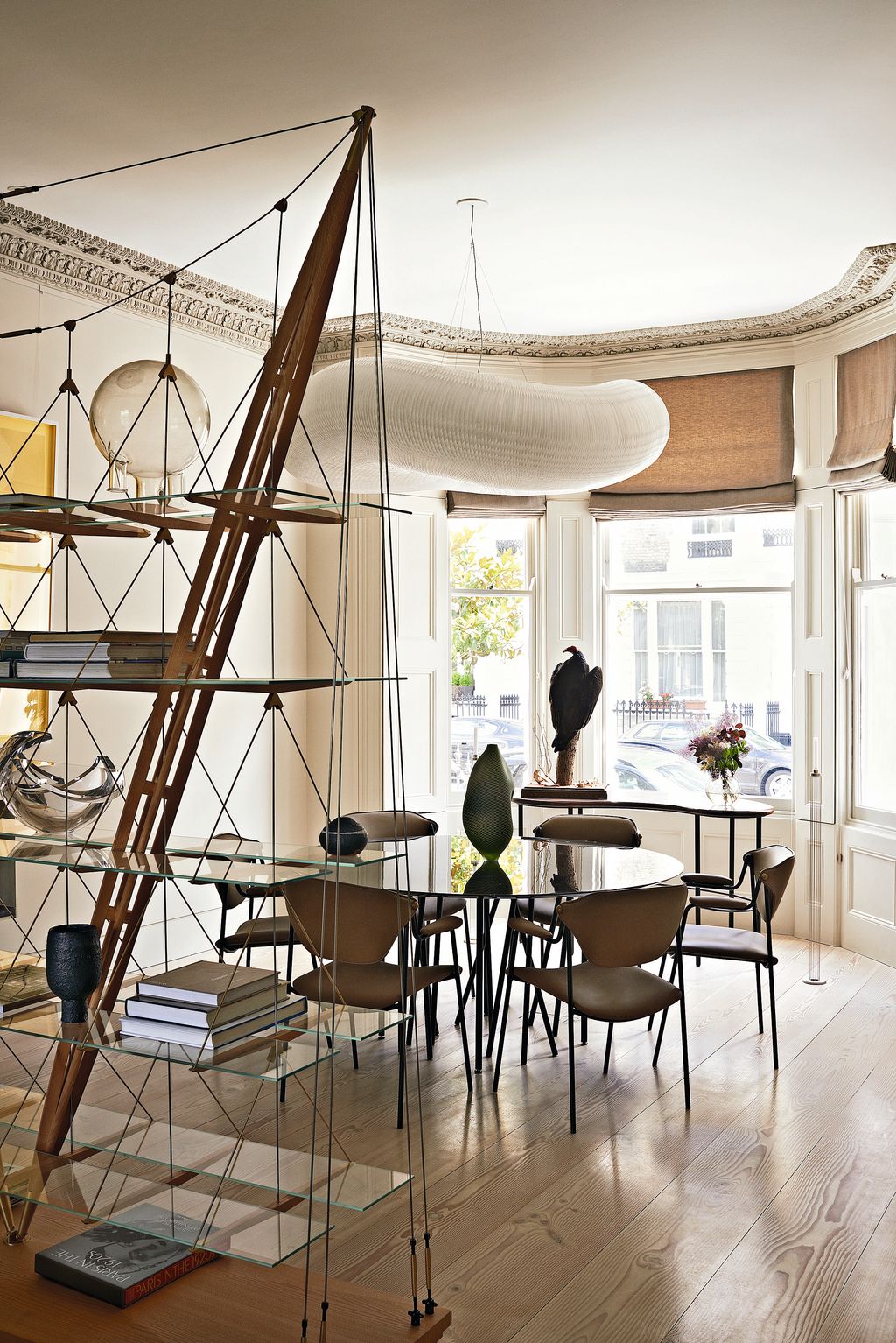 Designed by Franco Albini the ‘Veliero bookcase from Cassina stands between the dining and sitting areas in this flat...