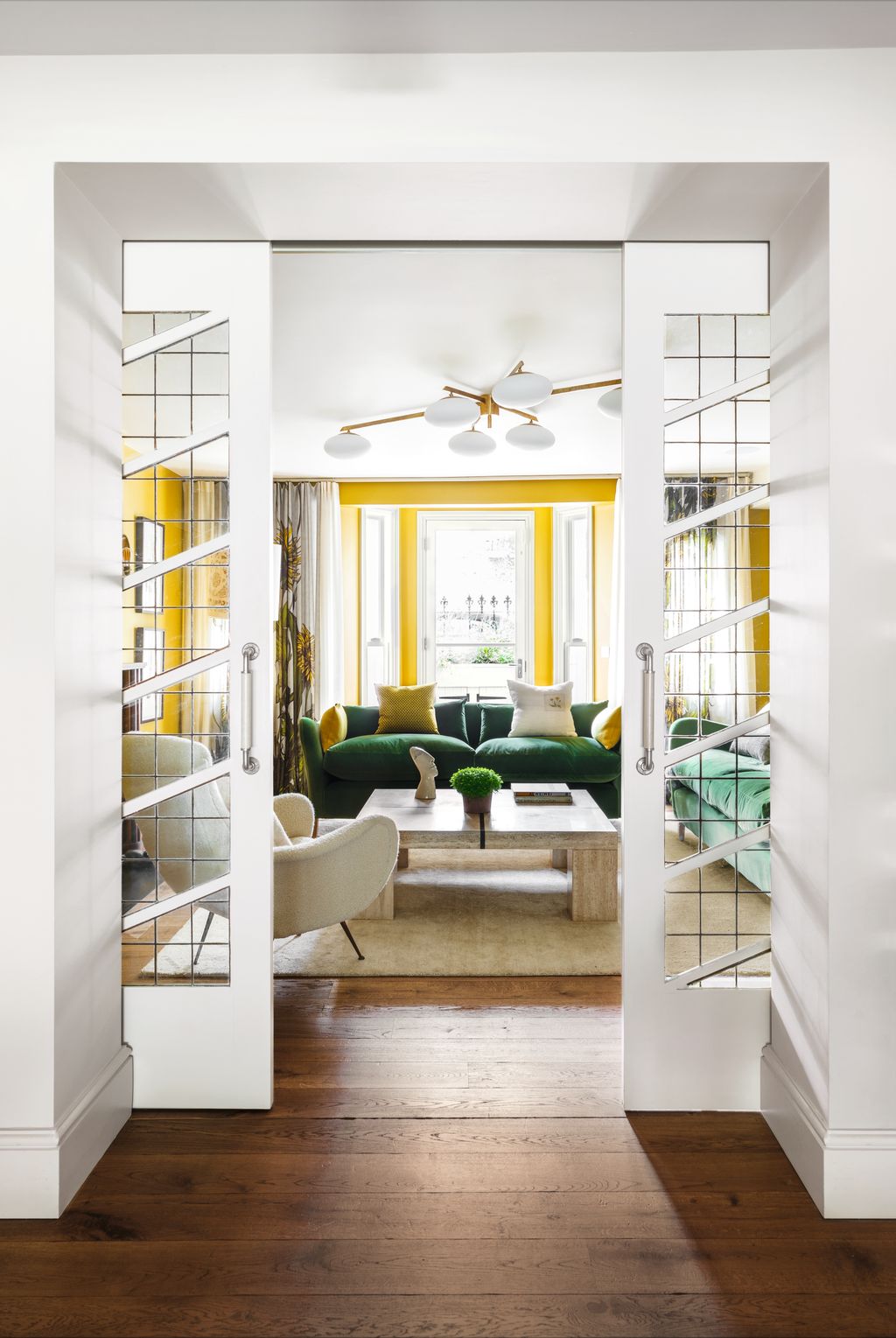 This sitting room designed by Retrouvius features reclaimed 1940s glass doors installed on a sliding track so they can...
