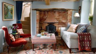 A sofa in Tinsmiths ‘Checker fabric in dawn grey picks up on walls in Paint  Paper Librarys ‘Porcelain V while an...