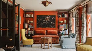The walls of the handsome drawing room have been treated with a deep orange specialist lacquer paint finish. Upholstered...