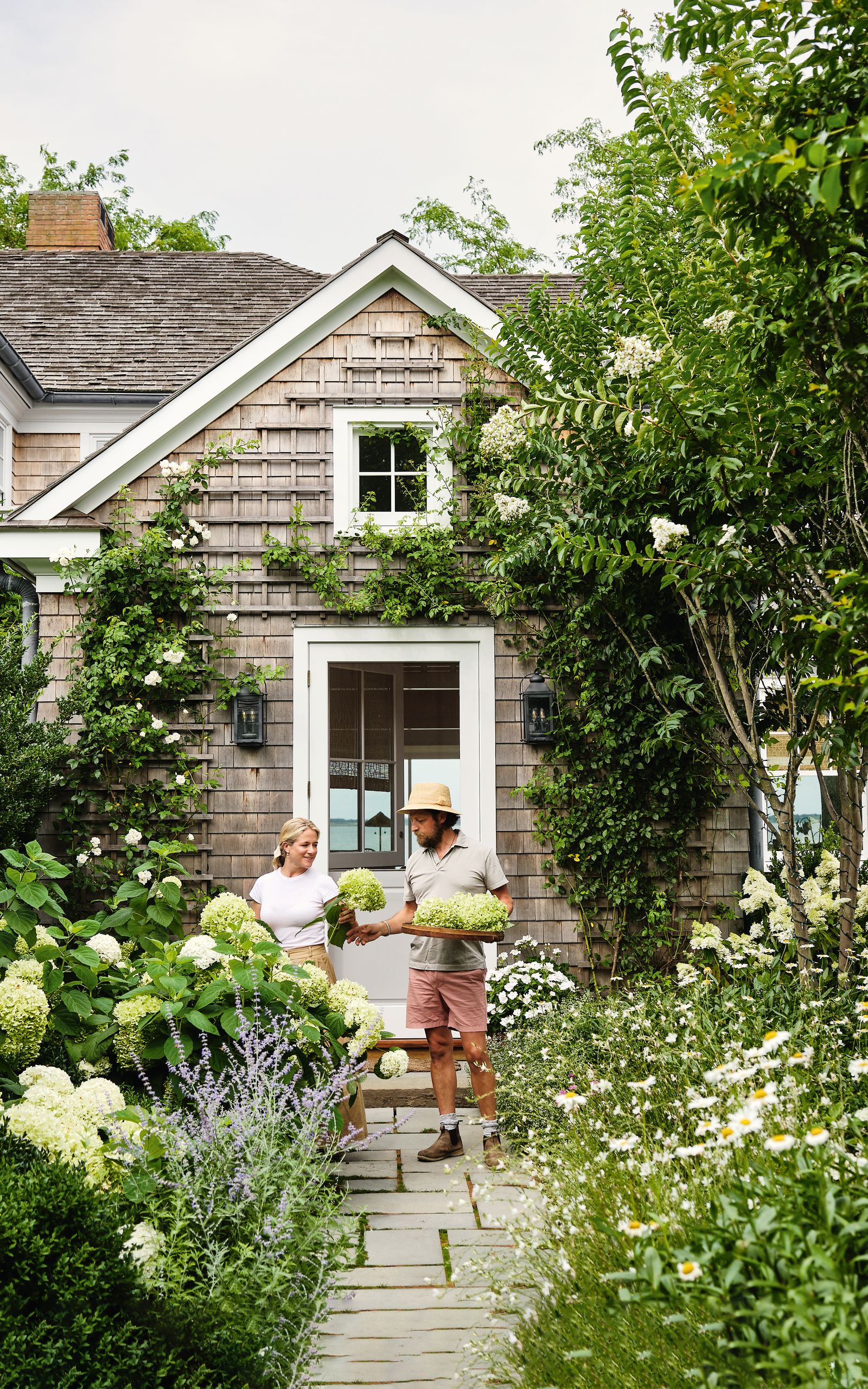 Lyndsay and Fitzhugh picking hydrangeas outside their Long Island home
