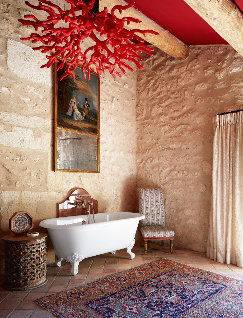 Farrow  Balls deep red ‘Incarnadine on the ceiling picks up on the distinctive coral light made by a local artist which...