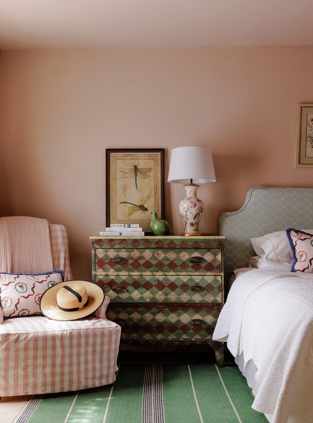 In the guest room of this house in Bath a folkpainted chest of drawers with a diamond pattern offsets walls in ‘Setting...