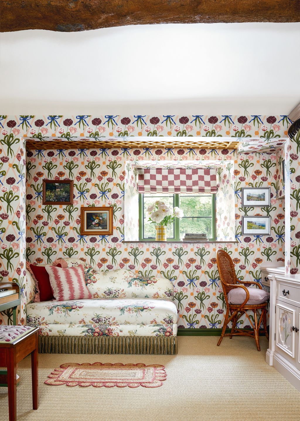 In Nadine Finnegans Cotswolds house a chaise longue covered in Colefax and Fowlers ‘Alicia Chintz in pinkgreen makes for...