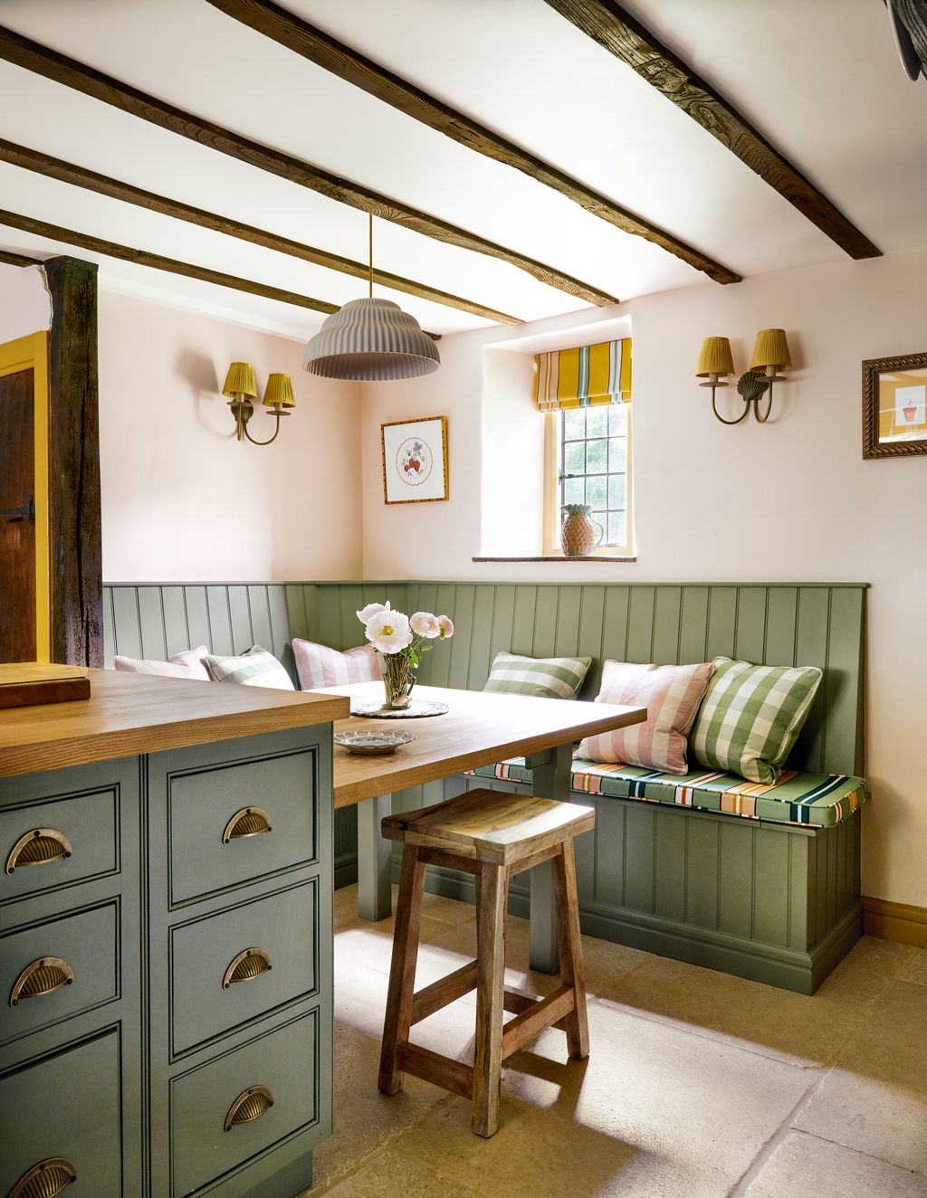 Ottolines ‘Sporty Stripes fabric in green on the bench seat and saffron for the blind picks up on bespoke joinery...