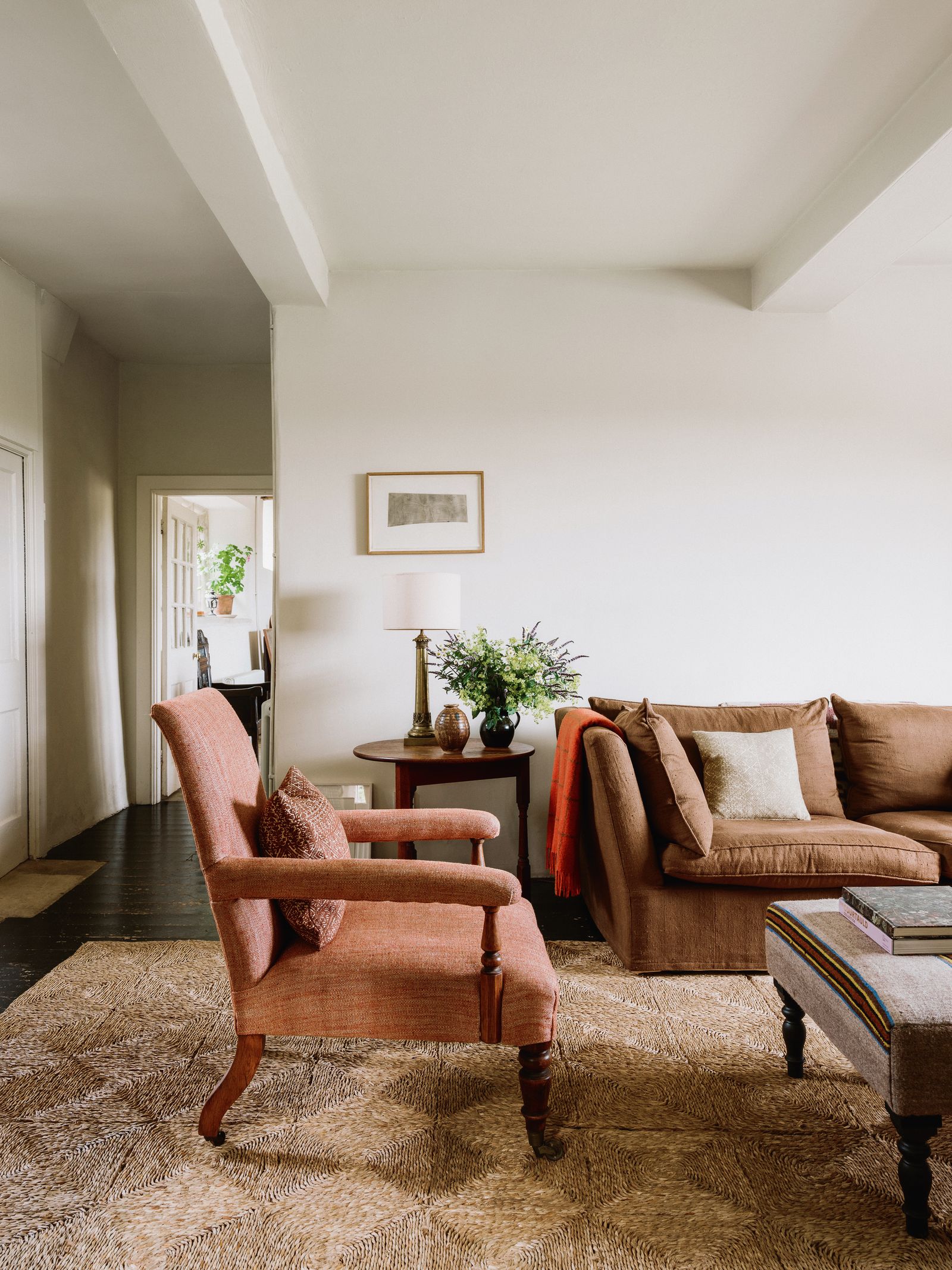 A Ben Nicholson etching of the monastery in Patmos  a present from Hamish Bowles  hangs beside a sofa and chair from...