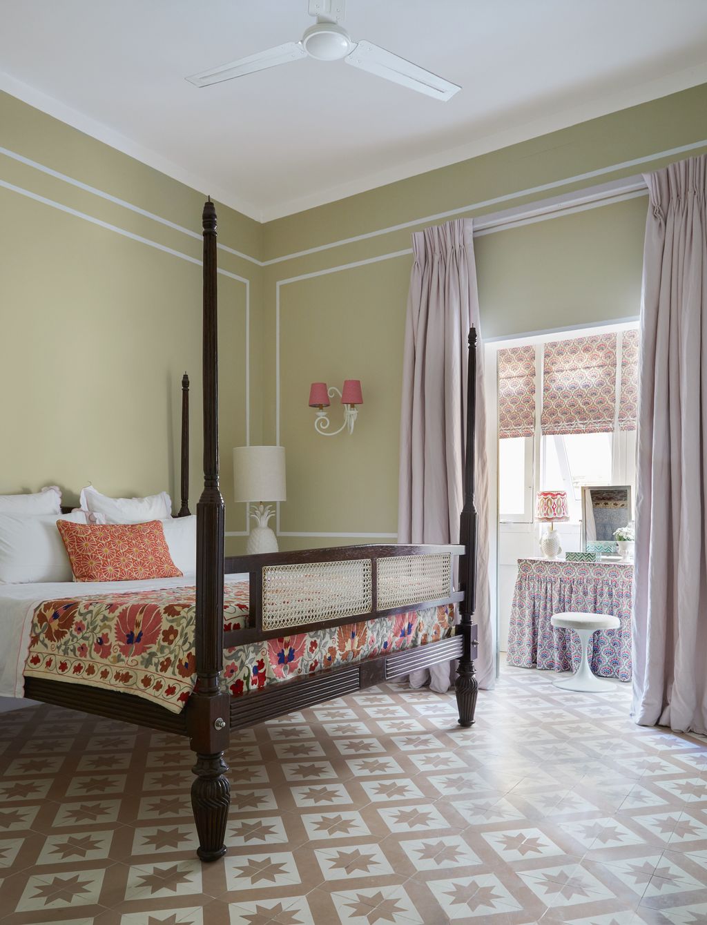 A bed made in Lamu Kenya is teamed with a colourful suzani and a red cushion both from the Grand Bazaar in Istanbul