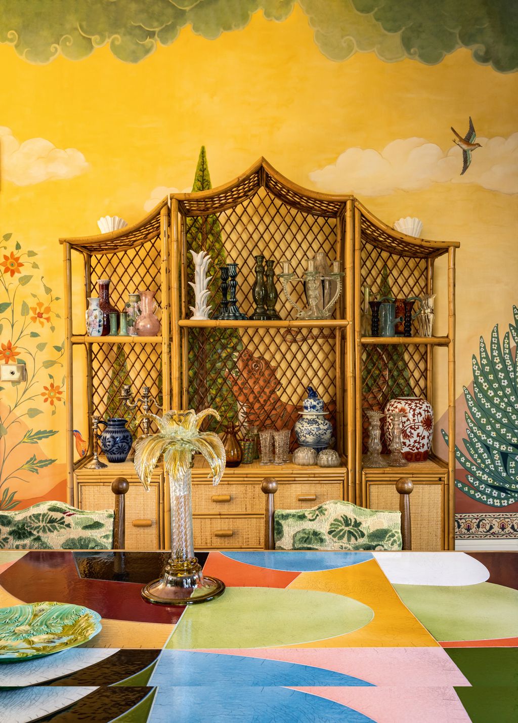 The antique bamboo dresser showcases Lauras collection of ceramic and glass vases and candlesticks all picked up at flea...