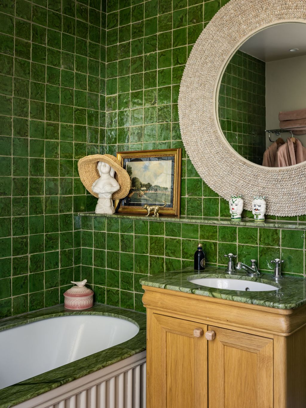 The ultraromantic bathroom in this Normandy house by Laura Gonzalez features an oak vanity with a striking green marble...
