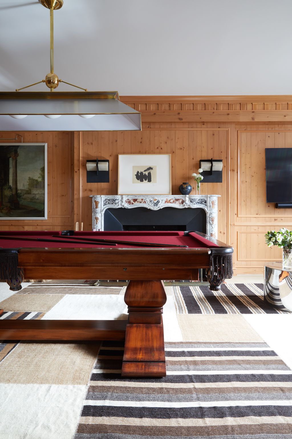 The main event downstairs is a handsome paneled billiardsroom—another feature one would normally find only in a...