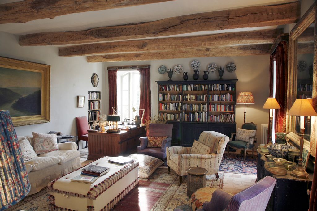 The library with a 19thcentury bookcase along the back wall topped by Roman pots and Iznik plates.