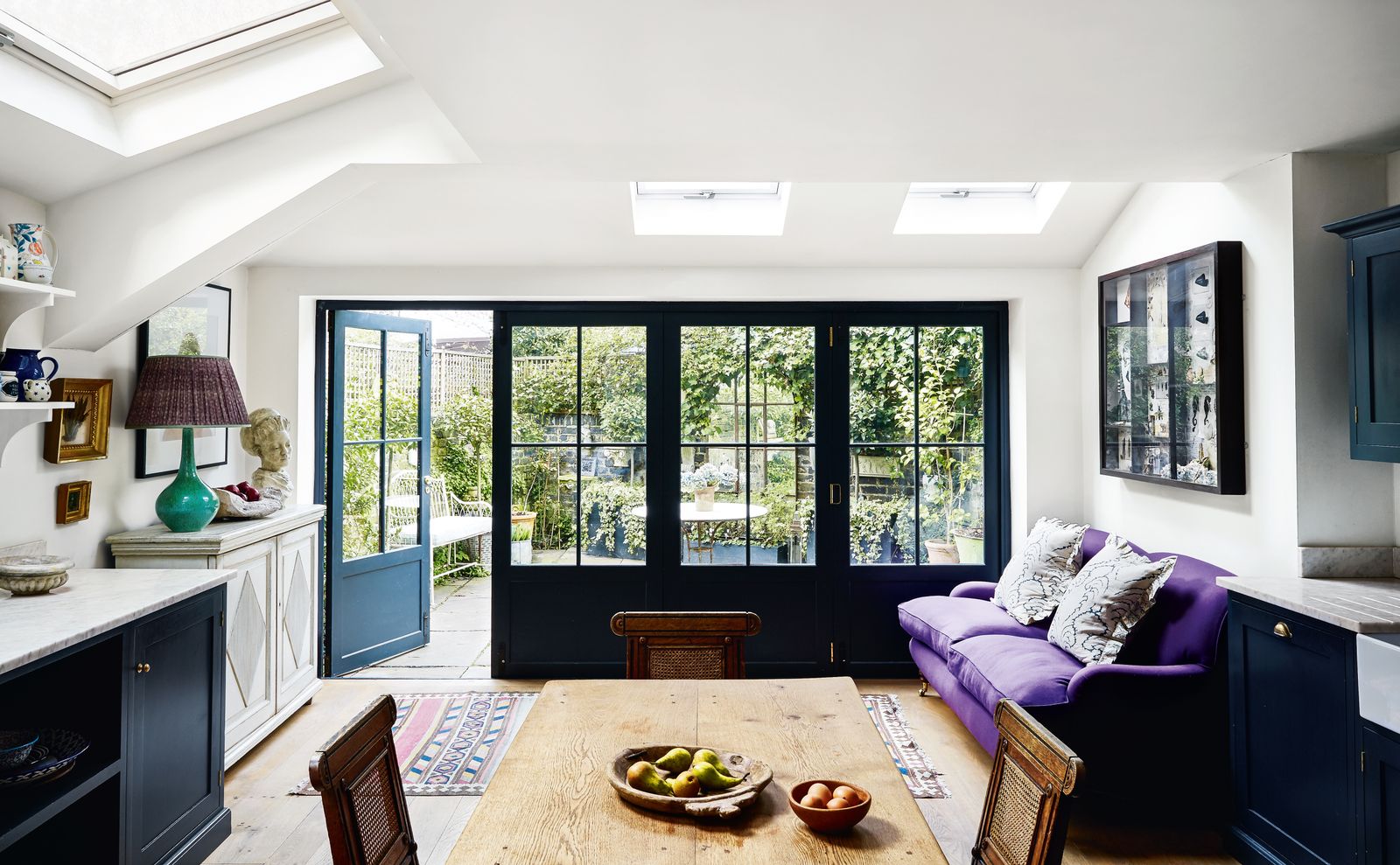 Cupboards by DeVol in ‘Pantry Blue topped with Vitruvius marble are combined with freestanding pieces including a...