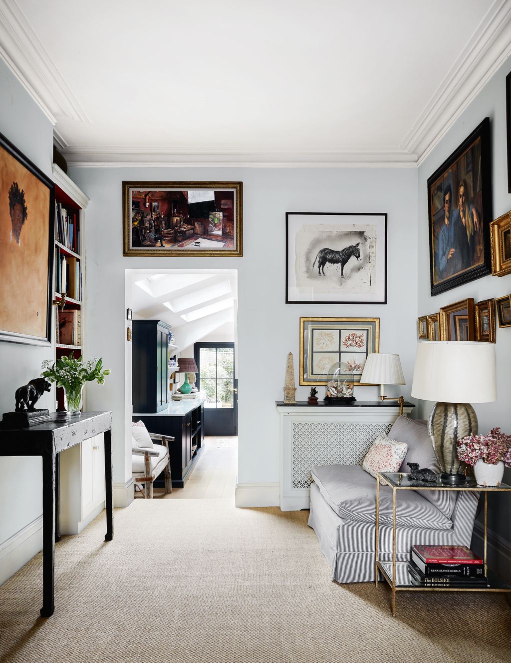 The etching of a zedonk is by artist friend Hugo Wilson. Above the sofa is Nick Bashalls portrait of Phoebe and Luke.