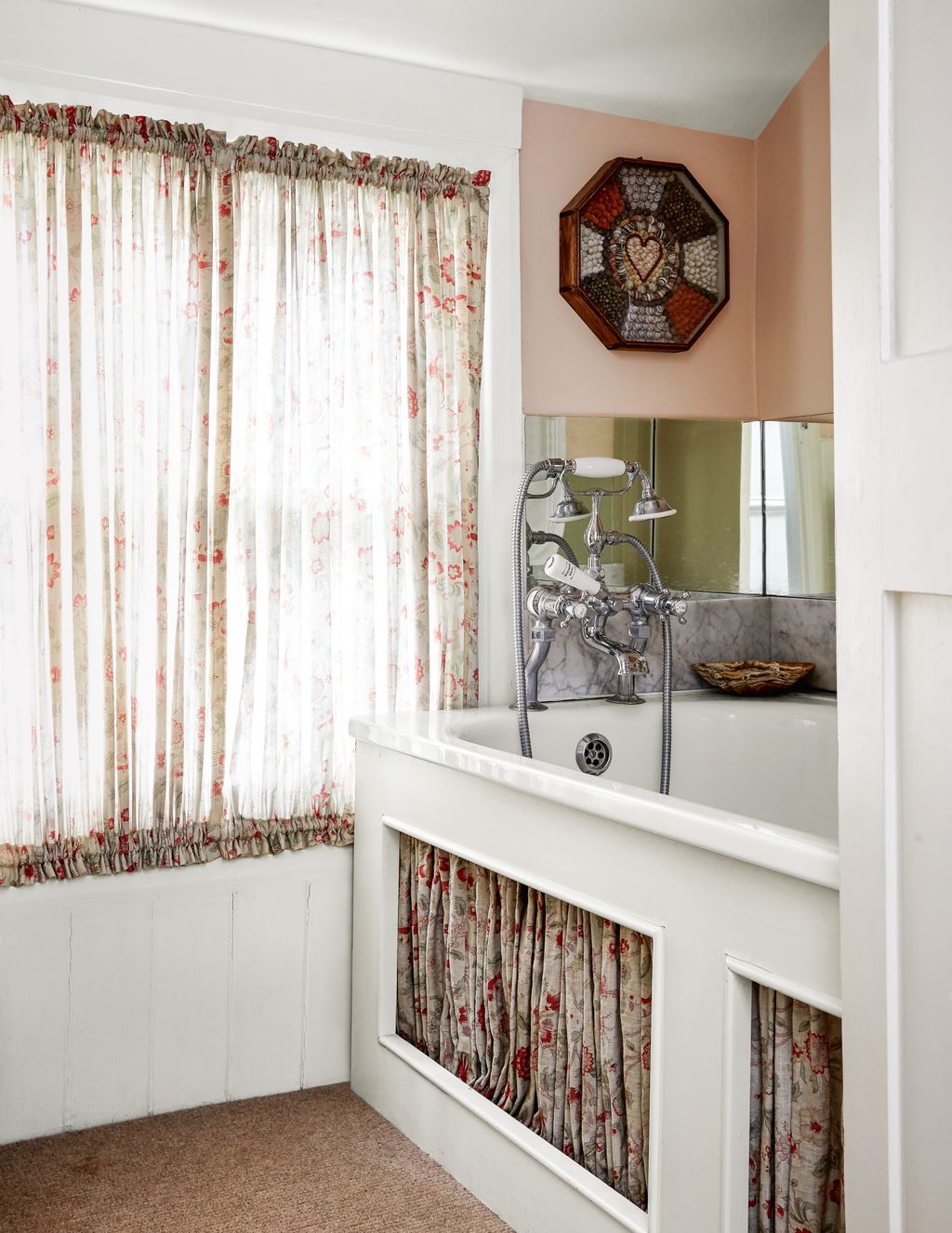 In the bathroom a pretty floral fabric by Claremont was used to make the gathered curtains and matching bath panels. The...